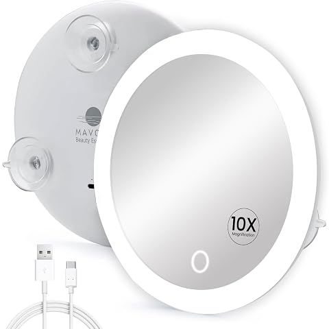 Miroir grossissant rond avec anneau LED fixé par ventouses sur une surface en pierre claire