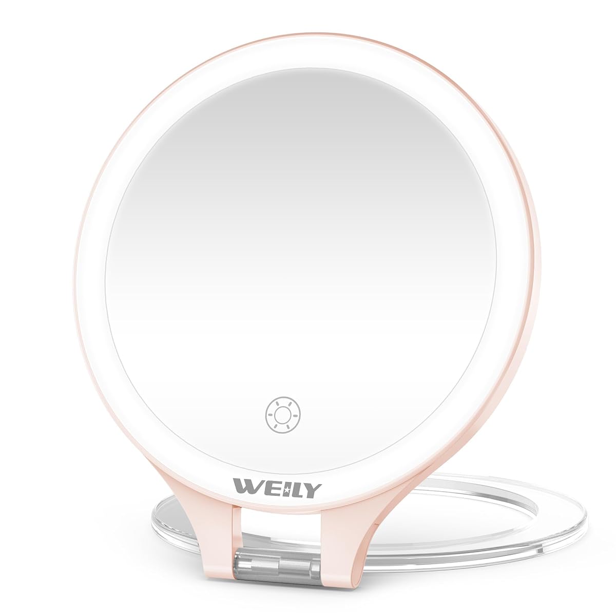 Miroir de maquillage rond rose à support pliable, posé sur une tablette dans une salle de bain claire