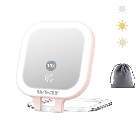 Miroir de poche rose pliable avec deux faces, éclairage LED et support orientable posé dans une salle de bain lumineuse