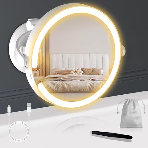 Miroir grossissant lumineux blanc à ventouse, fixé sur un mur clair de salle de bain.