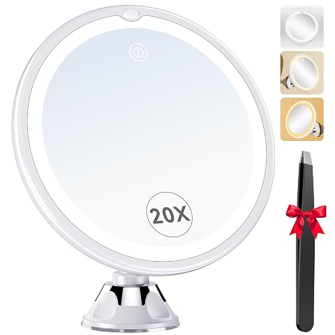 Miroir grossissant rond blanc à éclairage LED fixé par ventouse sur un miroir de salle de bain